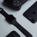 black iPhone 7 Plus and space gray Apple Watch with black sport band