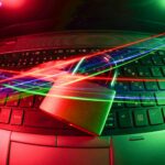 black laptop computer turned on with lights