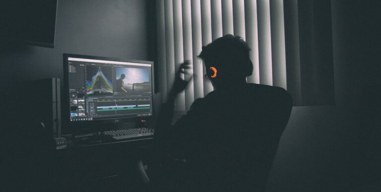 Creator working at a computer on an AI video production workflow