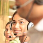 Customer service representatives wearing headsets for an AI receptionist alternatives guide