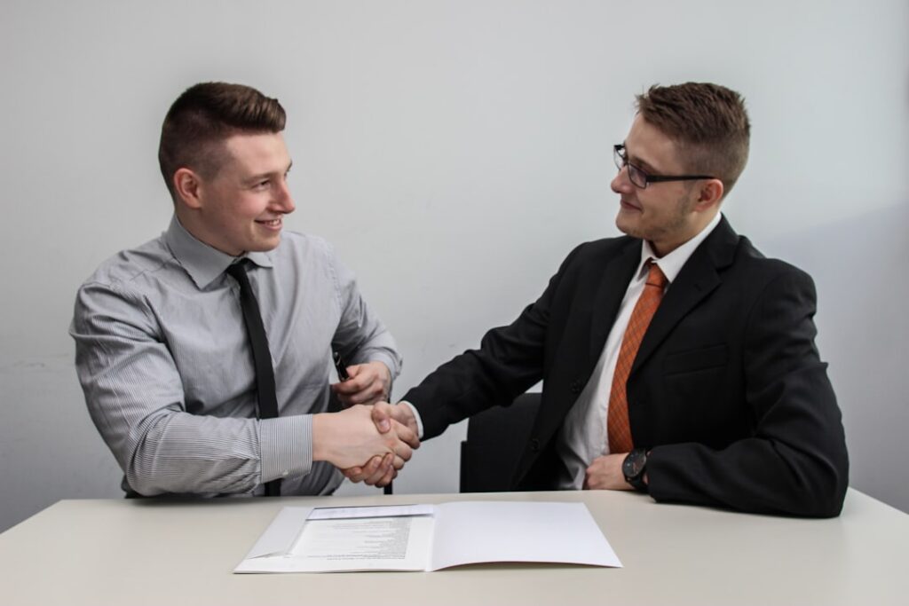Business partners shaking hands to represent affiliate and referral programs