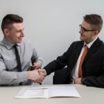 Business partners shaking hands to represent affiliate and referral programs