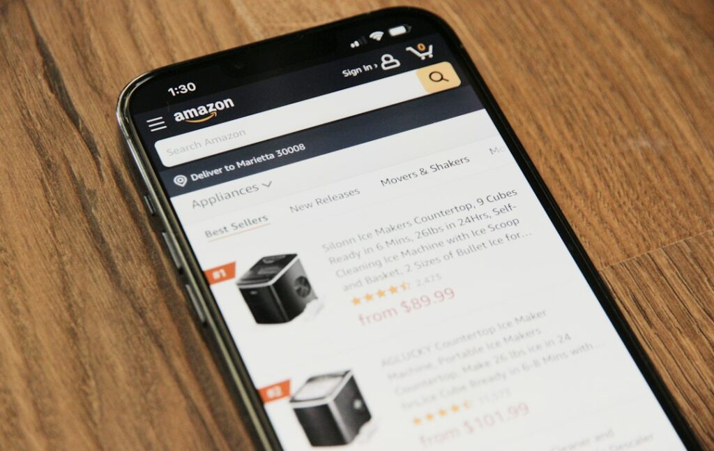 Smartphone and workspace for an Amazon seller product research guide