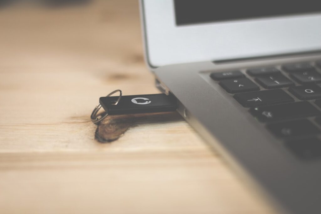 USB flash drive connected to a laptop for creating bootable Linux installation media