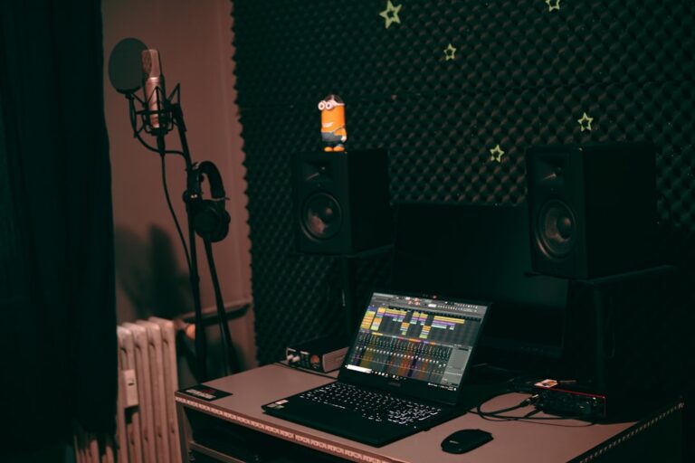 Home music production studio with laptop, audio gear and keyboard