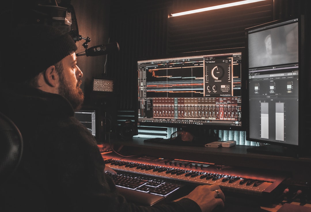Music producer working at a computer in a home studio