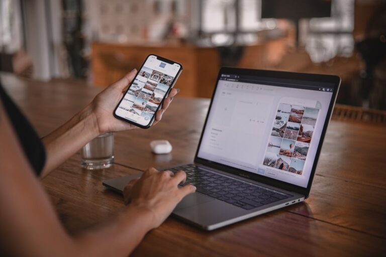 Person using a smartphone and laptop to manage a cloud photo library