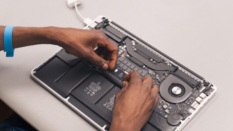 Technician working on a laptop during computer repair and data recovery