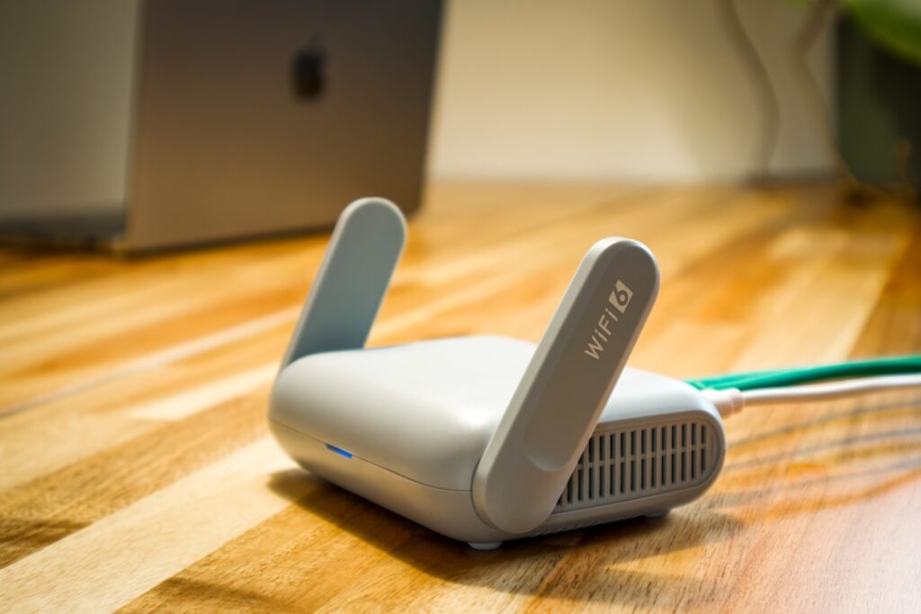Modern wireless router with Ethernet and power cables on a desk