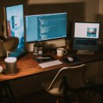 Modern computer workspace with multiple screens and technology equipment