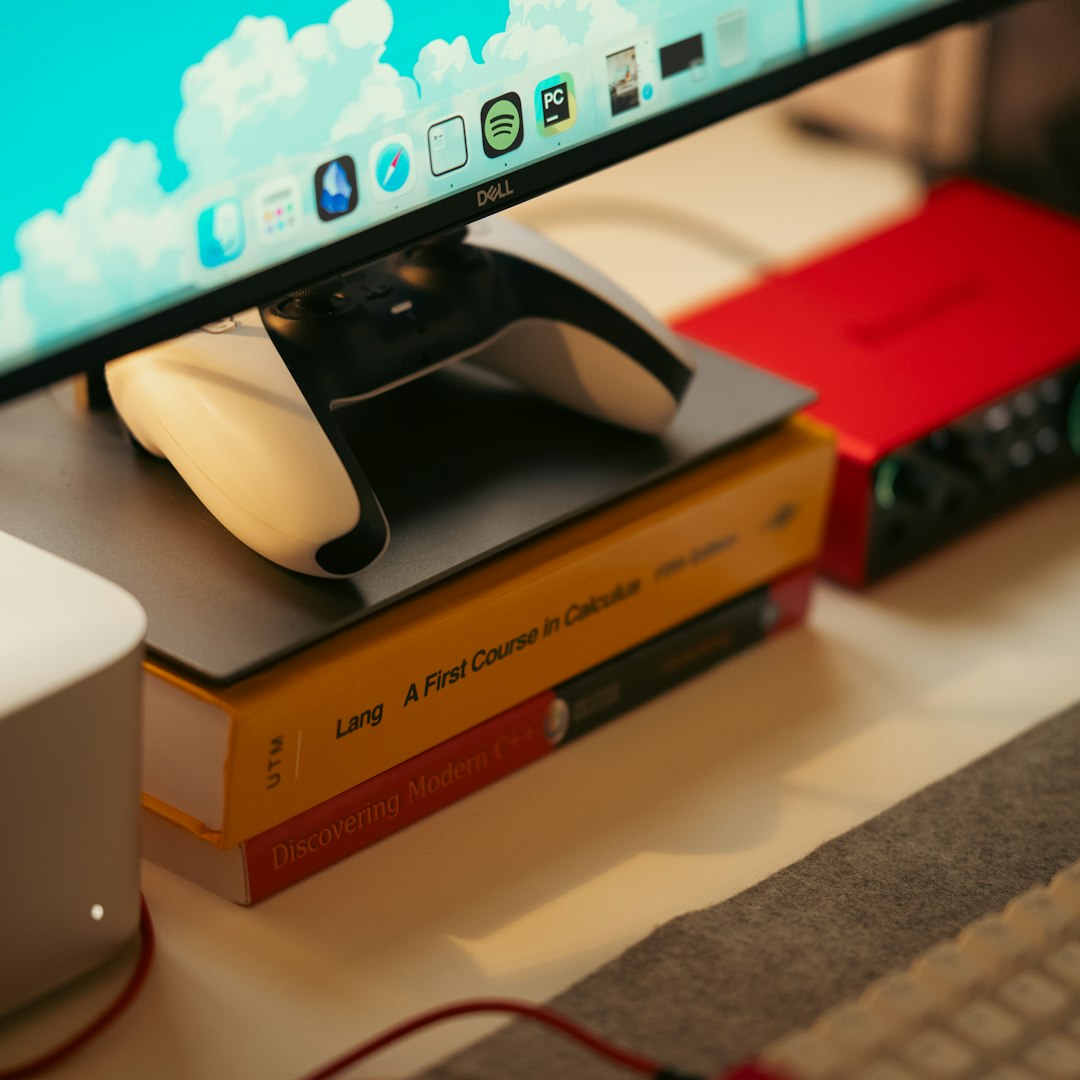 Gaming controller beside a computer display for retro gaming storage