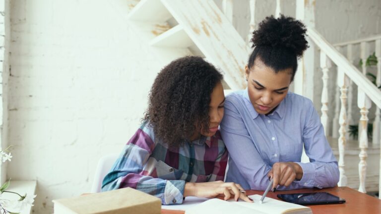 People collaborating at a laptop for small business client management