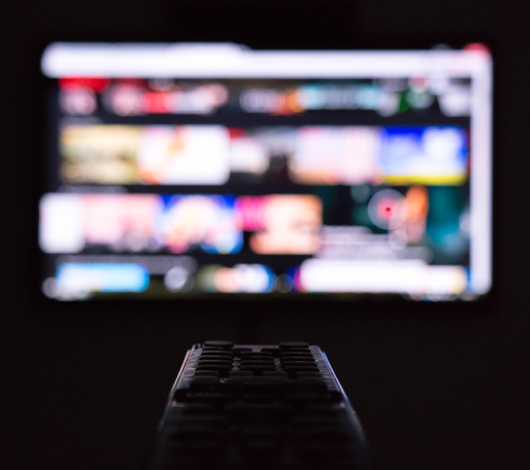 Remote control in front of a television for streaming media and smart TV use