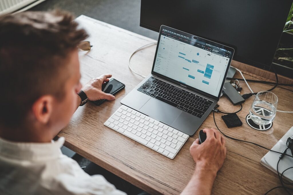 Person using a laptop to configure Windows 11 settings and productivity options