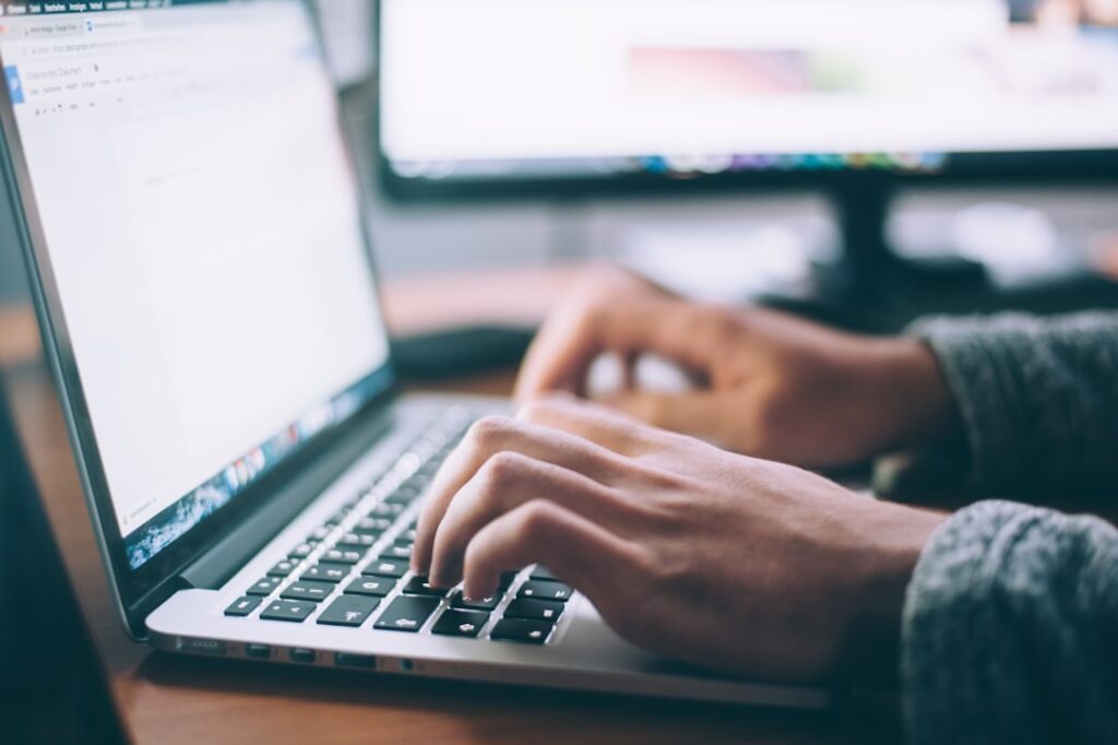 Laptop workspace for comparing WordPress hosting services