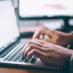 Laptop workspace for comparing WordPress hosting services